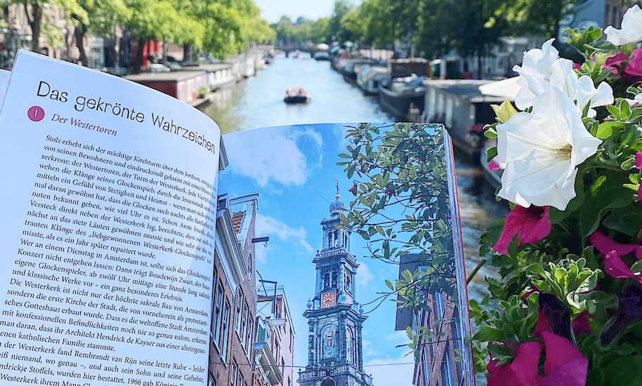 Landmark Westerkerk in the Amsterdam Book of Happy Places in front of a canal